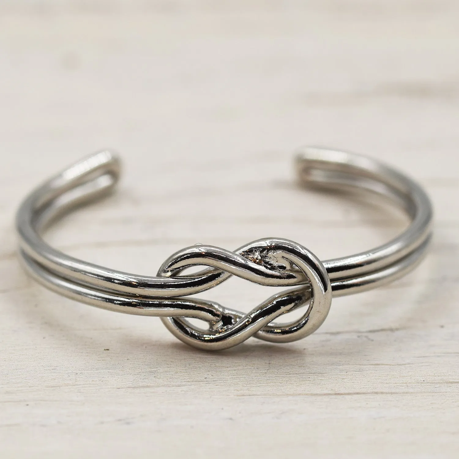 Delicate open bangle with rope knot feature