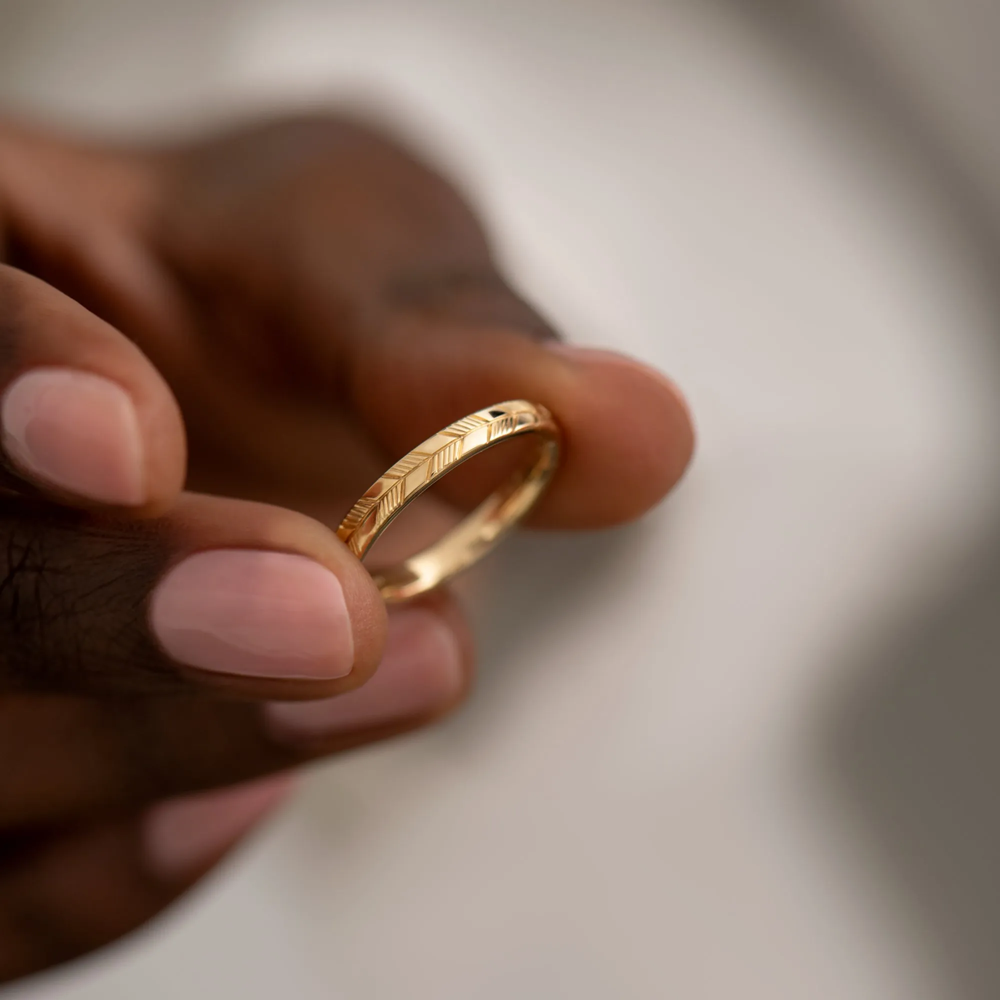 Golden Wedding Band with an Abstract Feather Engraving