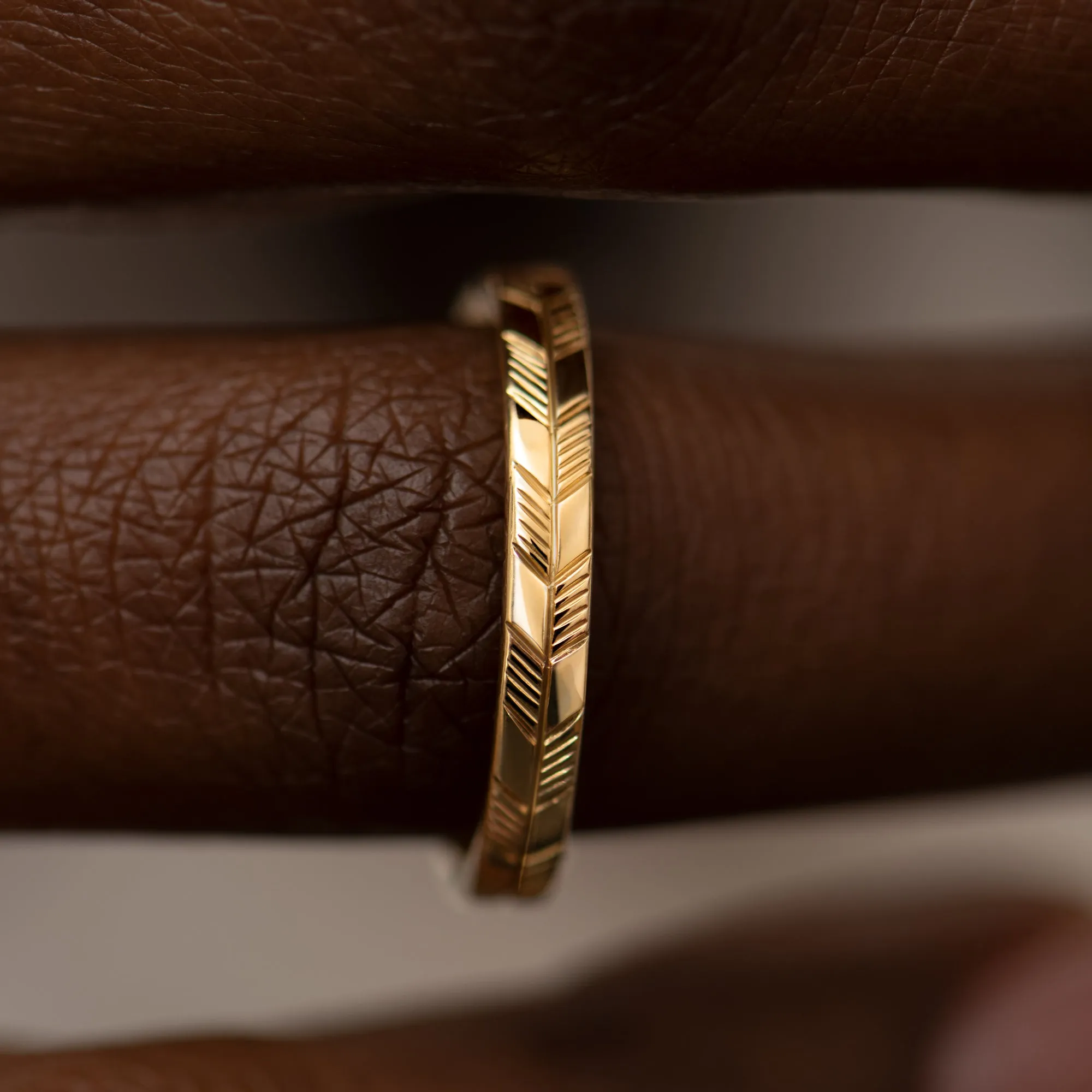 Golden Wedding Band with an Abstract Feather Engraving