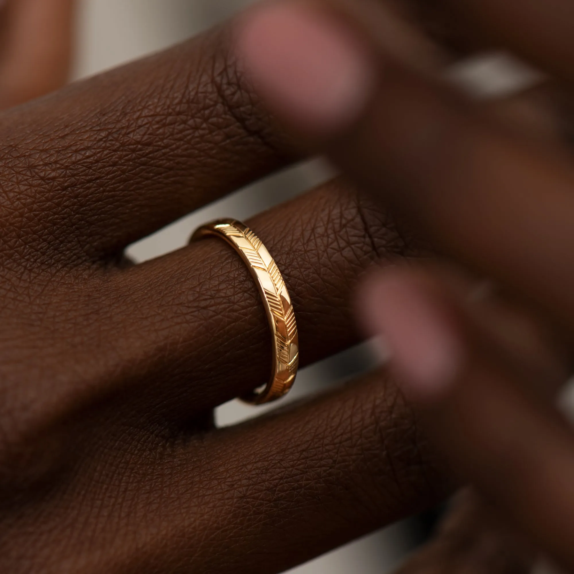 Golden Wedding Band with an Abstract Feather Engraving