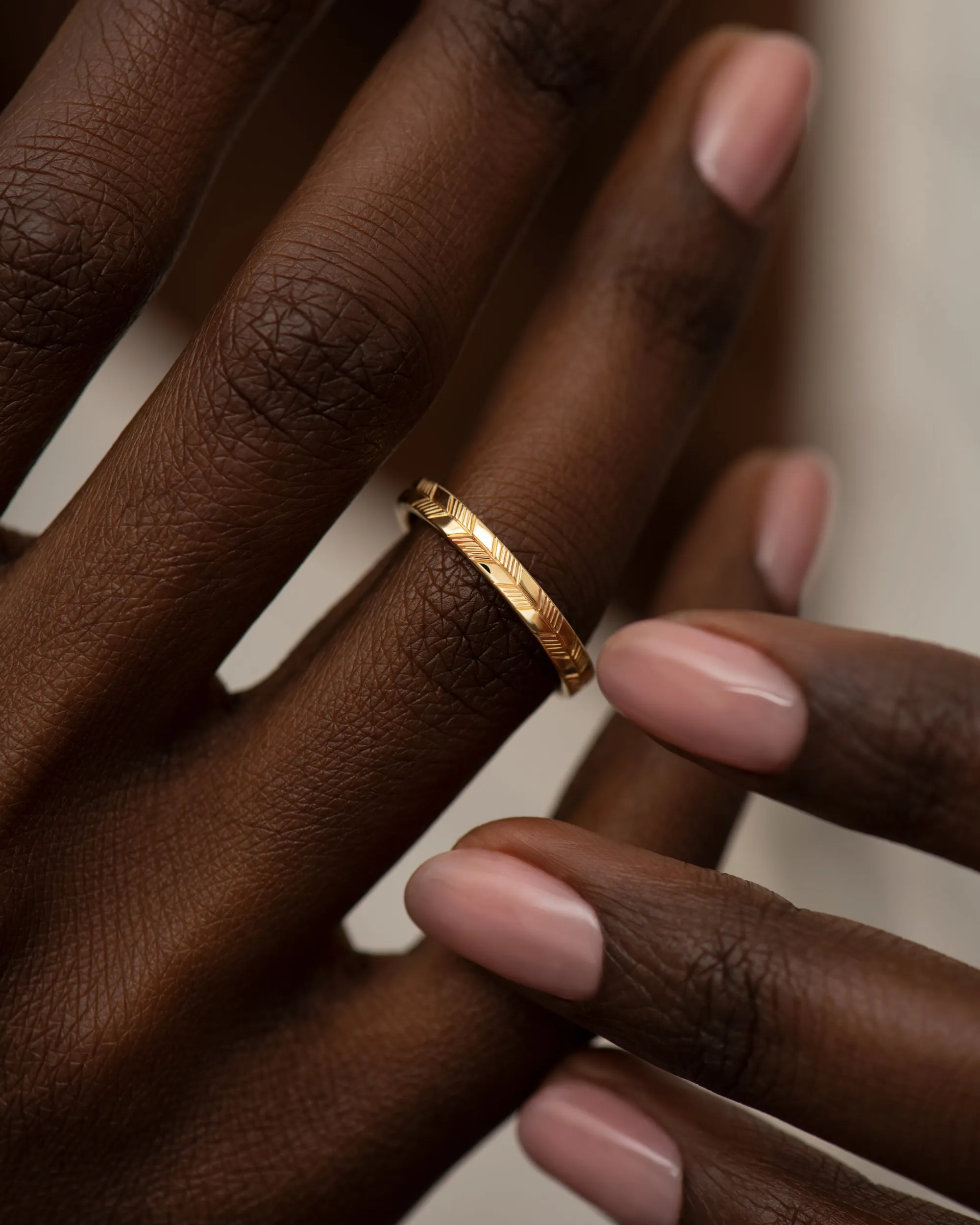 Golden Wedding Band with an Abstract Feather Engraving